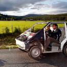 Crown Prince Haakon gets to try an electric car drawn by dogs at he Tyrili Foundation (Photo: Lise Åserud / Scanpix).