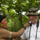 The King is painted in the face by Daví Kopenawa, the leader of the Yanomami. The red paint is obtained from the seeds of the annatto bush. Published 4 May 2013. Handout picture from the Royal Court. For editorial use only, not for sale. Photo: Rainforest Foundation Norway / ISA Brazil.
