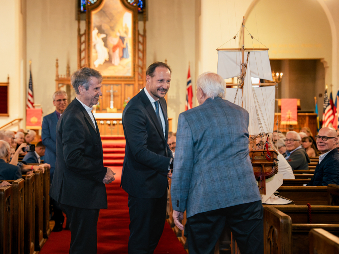 Hans Sandom explains the new church ship he has crafted – a model of the Restauration, the first Norwegian emigrant ship to the United States. Photo: Ola Vatn, The Royal Court