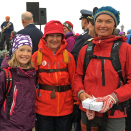 Queen Sonja with Aviaja Kleist, Mathias Edin Berg (10) and Johanne Eline Angelsen by the cairn. Photo: Ida Maria Pinnerød